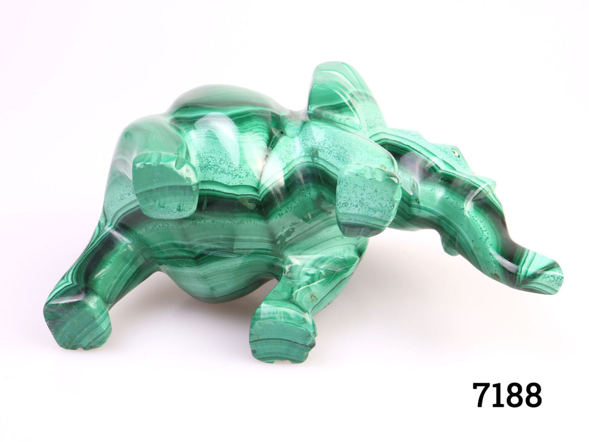 Heavy elephant ornament carved out of one piece of malachite. Smooth finish with no rough edges. Photo of underbelly