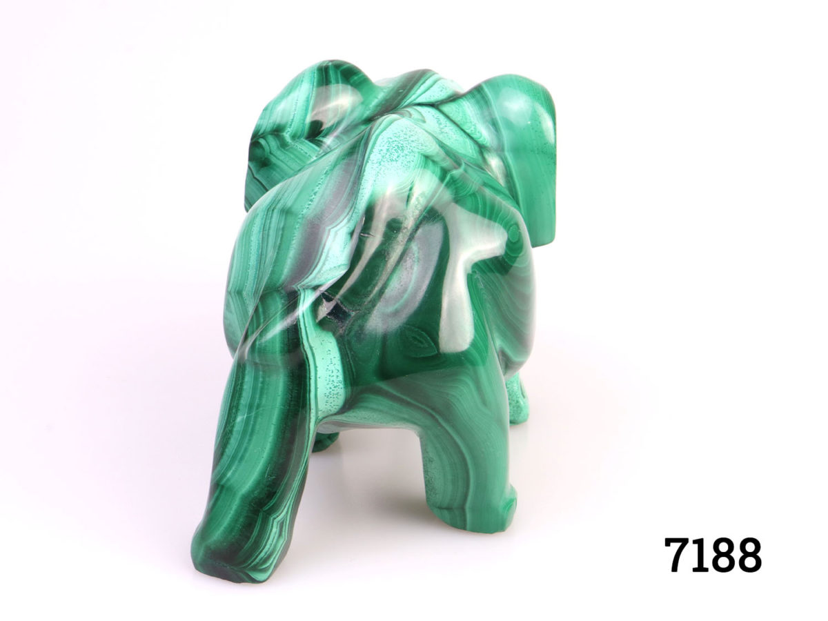 Heavy elephant ornament carved out of one piece of malachite. Smooth finish with no rough edges. Photo of backside of elephant
