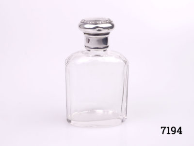 London assayed sterling silver topped scent bottle. Fully hallmarked on the neck of the lid c1928. Empty small cartouche on lid for personalisation. (A couple of small dents on the lid) Main photo showing bottle with lid on from side angle view