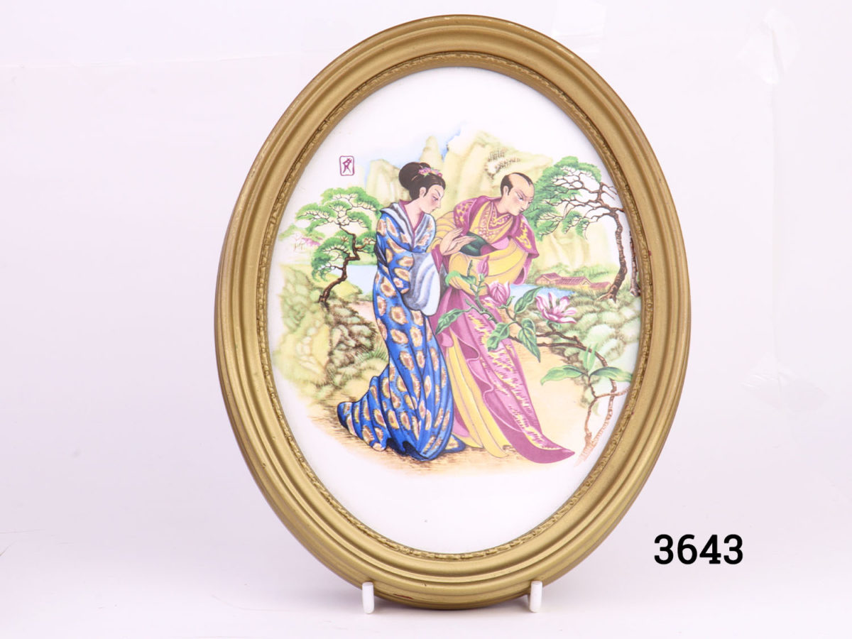 Pair of vintage oval gilt framed Oriental porcelain pictures. Hand-painted with scenes of courting couples in an Oriental setting. Felt peeling at back. Photo of picture showing couple admiring magnolia blossoms