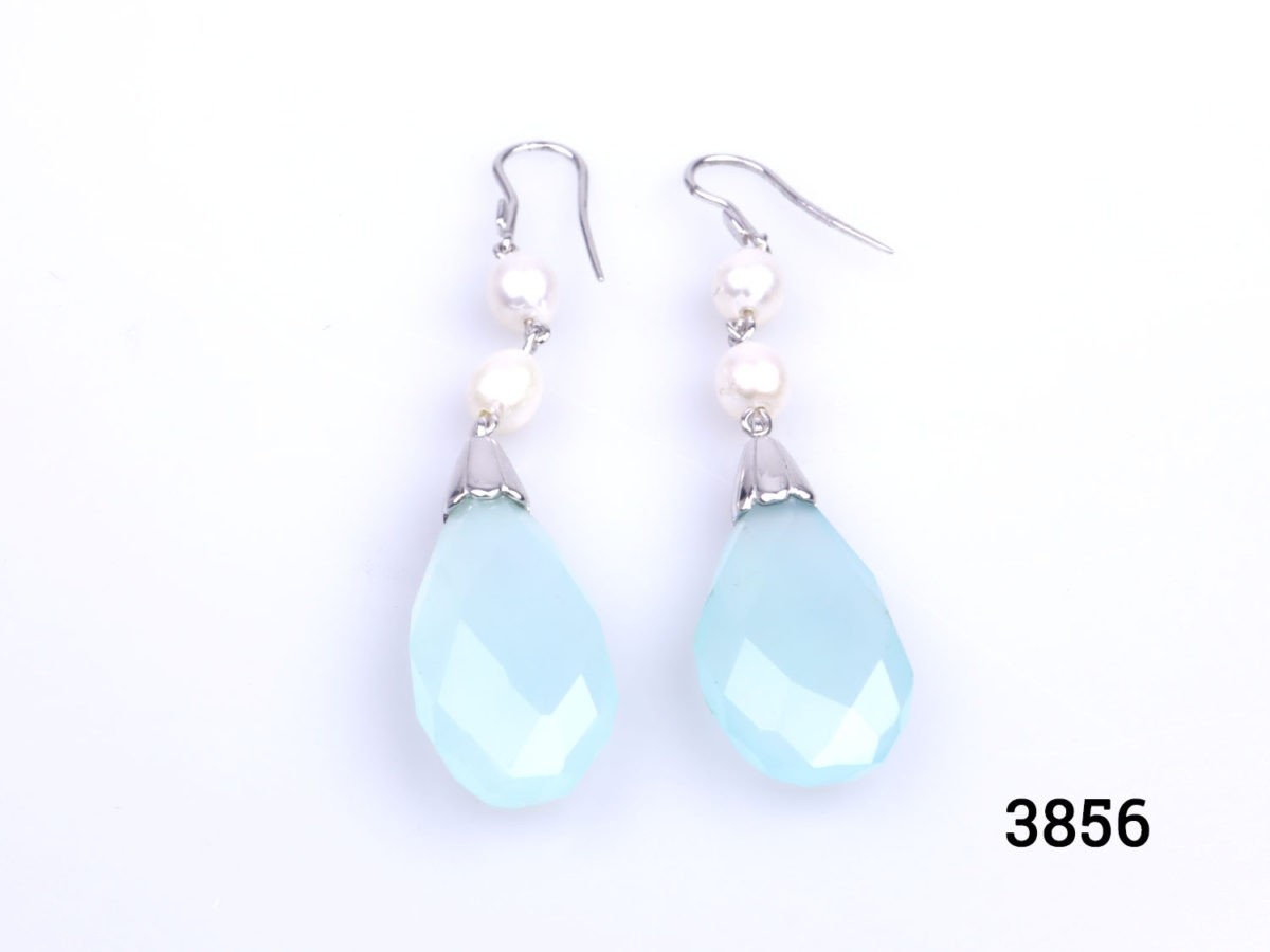 Unique sterling silver dangle earrings with pearls and tear drop shaped faceted natural aquamarine. Hook fastening for pierced ears. Hallmarked 925 for sterling silver. Drop length 65mm from top of hook. Aquamarine measures 15mm at widest point.
