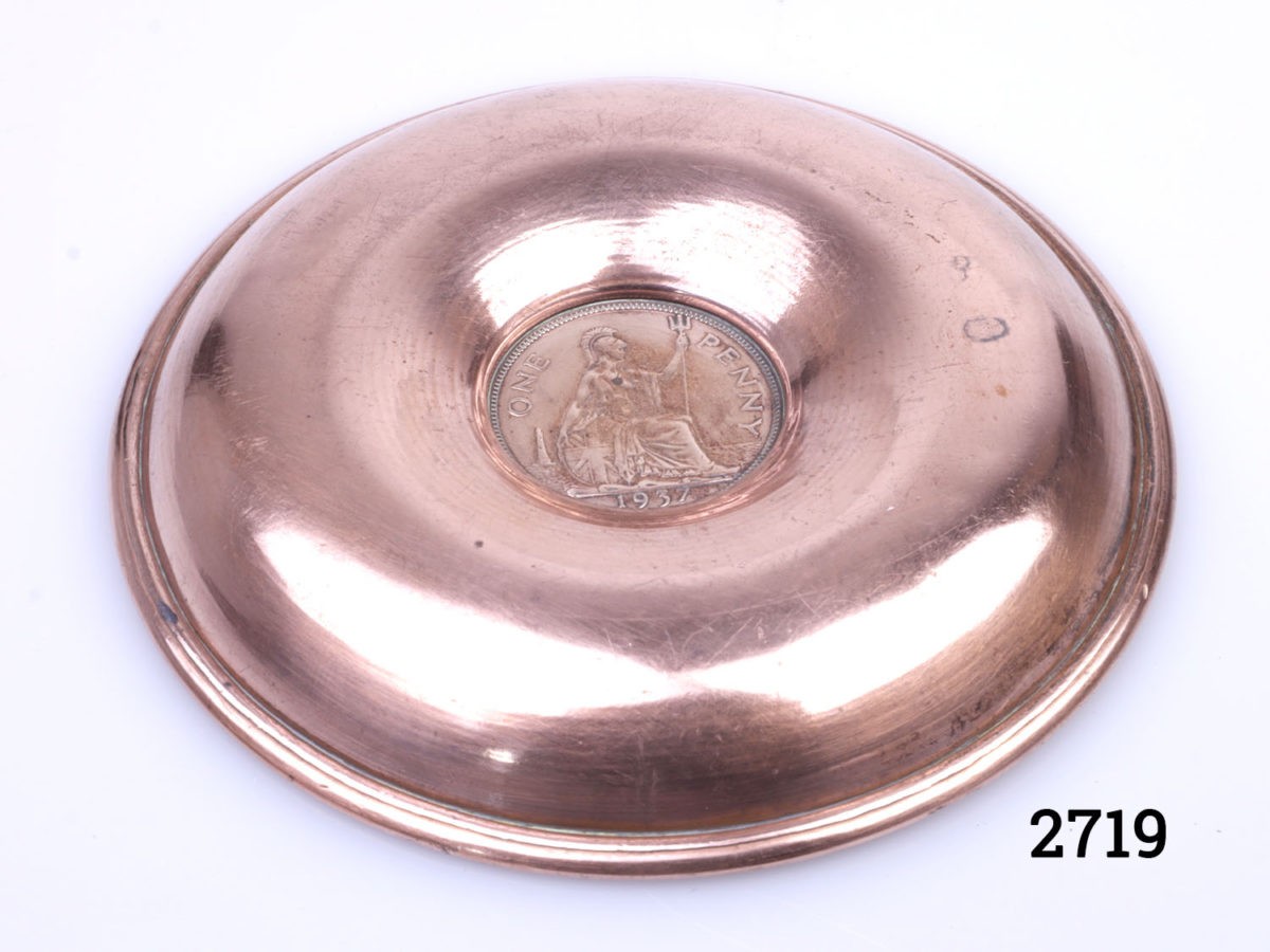 Small circular copper pin/coin tray with a 1937 copper one old pence to the centre. Measures 108mm in diameter. Photo of base of tray showing the reverse of copper old penny bearing the year