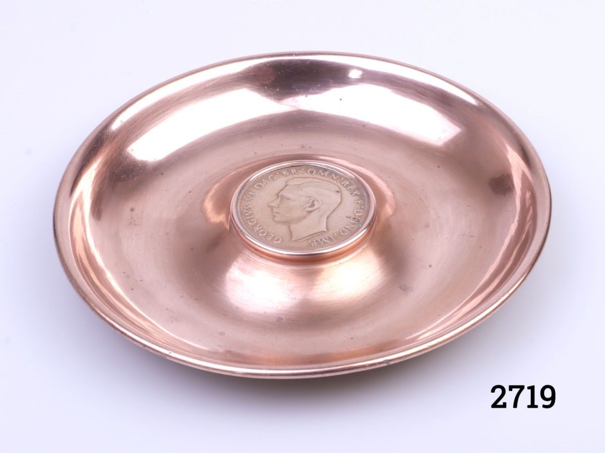 Small circular copper pin/coin tray with a 1937 copper one old pence to the centre. Measures 108mm in diameter. Photo of tray from a slightly raised angle showing interior