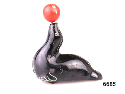 1950s vintage tin plate performing seal toy with ball. Made in England Main photo showing seal from the side with head facing left