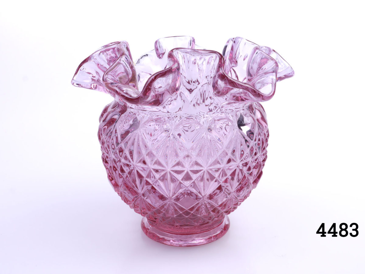 Vintage Fenton pale cranberry glass vase. Crinkle rimmed lip and diamond shaped pattern to body. Measures 50mm in diameter at base and 125mm in diameter across the top Main photo showing whole vase from eye level