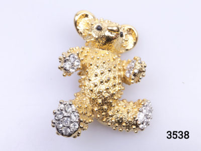 Vintage gilt metal Teddy bear brooch. Bobble effect gilt metal fur and crystal glass paws. Numbered 5477 at the back Main photo showing teddy bear from the front and right way up (Head at the top)
