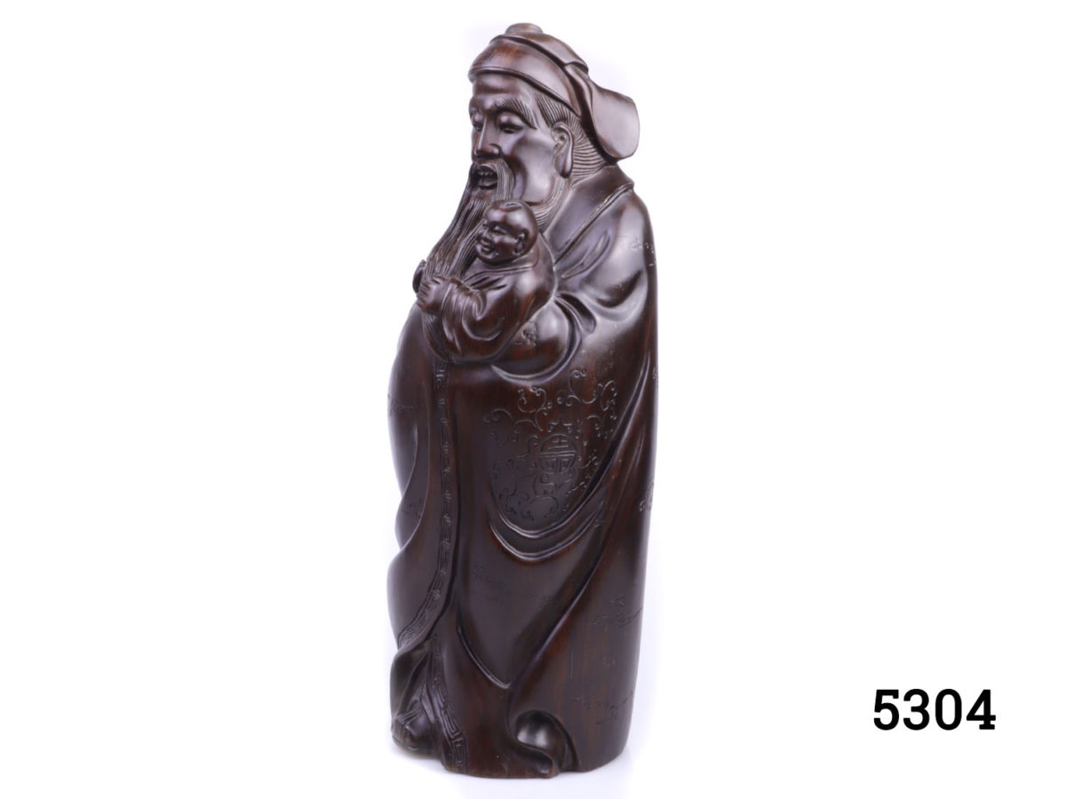 Vintage Oriental hardwood figure of happiness deity Lu. Intricately carved from one heavy block of hardwood. Base measures 140mm by 125mm. Side view photo of whole figure