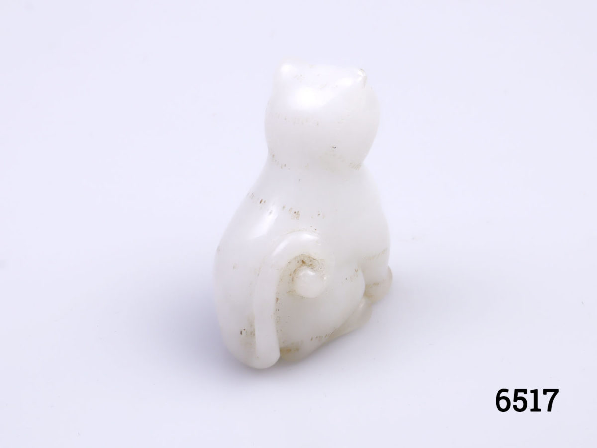 Vintage Oriental white jade cat ornament. Carved from one piece of jade and in a seated pose. Photo of back of cat showing tail