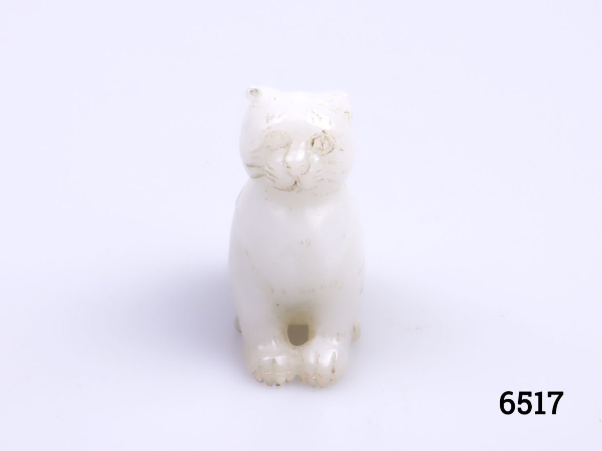 Vintage Oriental white jade cat ornament. Carved from one piece of jade and in a seated pose. Photo of front view of cat