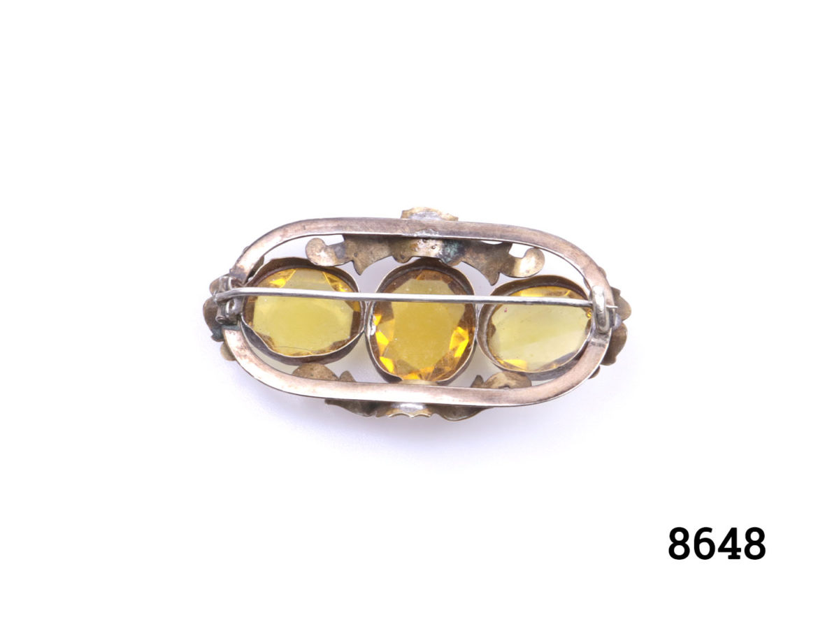 Vintage Pinchbeck brooch with 3 oval cut yellow glass beads. (Some scratching and minor chips to stones) Photo of back of brooch