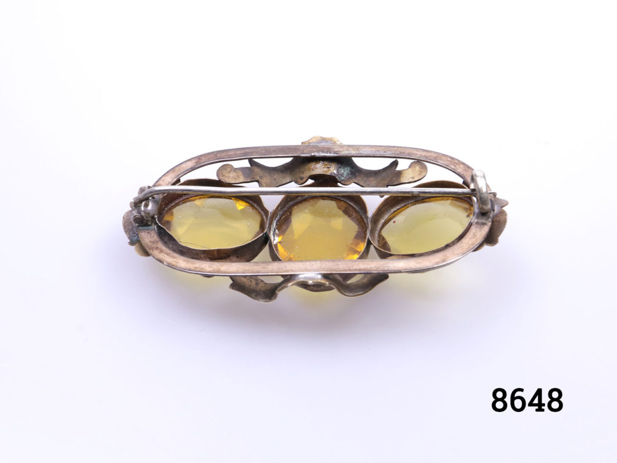 Vintage Pinchbeck brooch with 3 oval cut yellow glass beads. (Some scratching and minor chips to stones) Close up photo of back of brooch showing depth