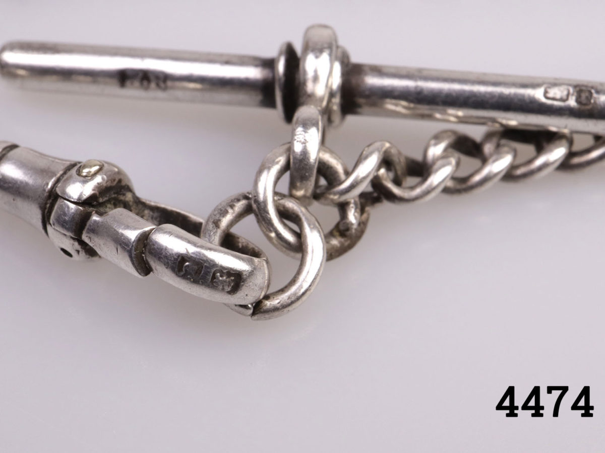 Vintage short sterling silver Albert pocket watch chain. Lion passant mark on each link. Close up photo of the hallmark on the lobster clasp