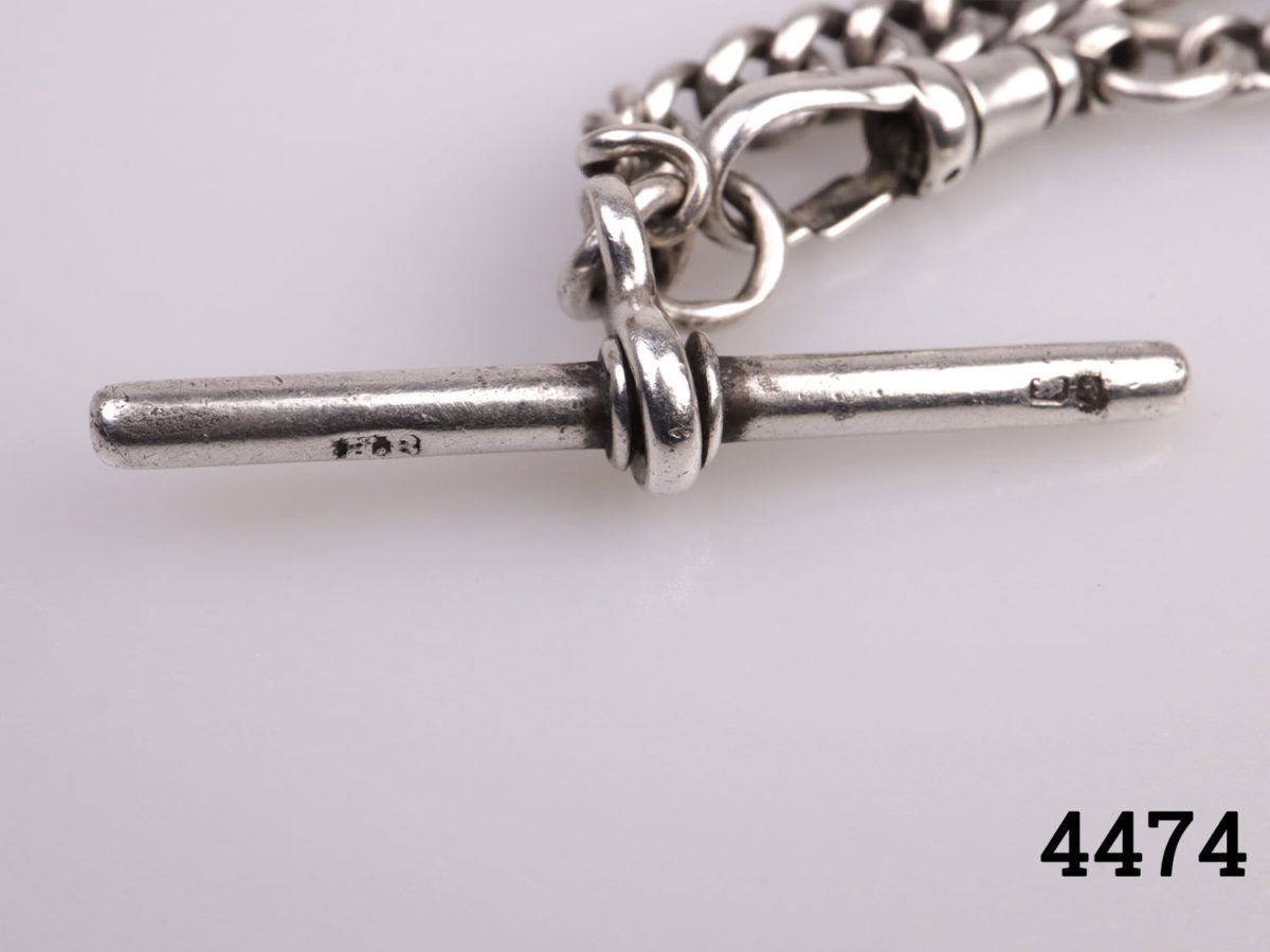 Vintage short sterling silver Albert pocket watch chain. Lion passant mark on each link. Close up photo of the bar clasp showing hallmark