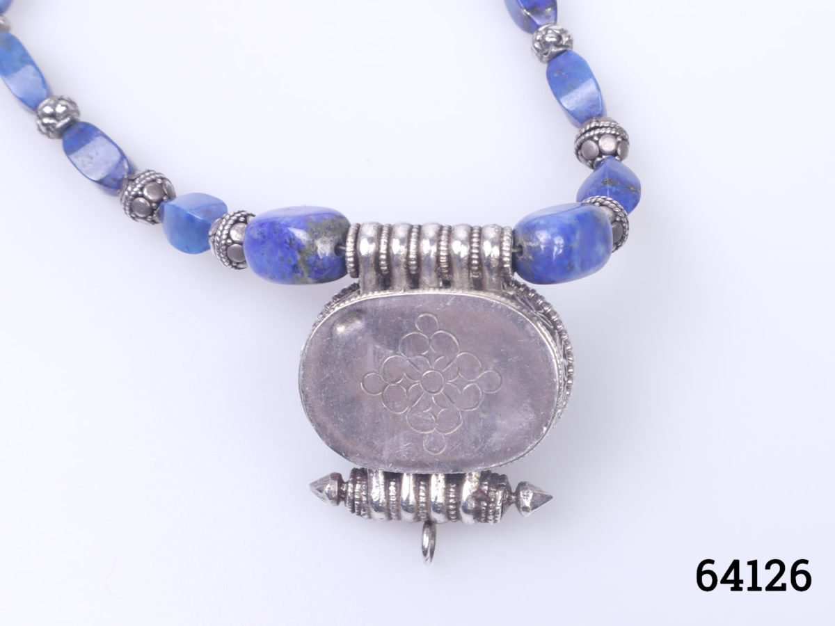 Vintage Tibetan silver necklace with turquoise and lapis lazuli beads and a lapis lazuli box pendant. Pendant has a secret compartment that opens at the back and measures 38mm long by 30mm wide Close up photo of the back of pendant