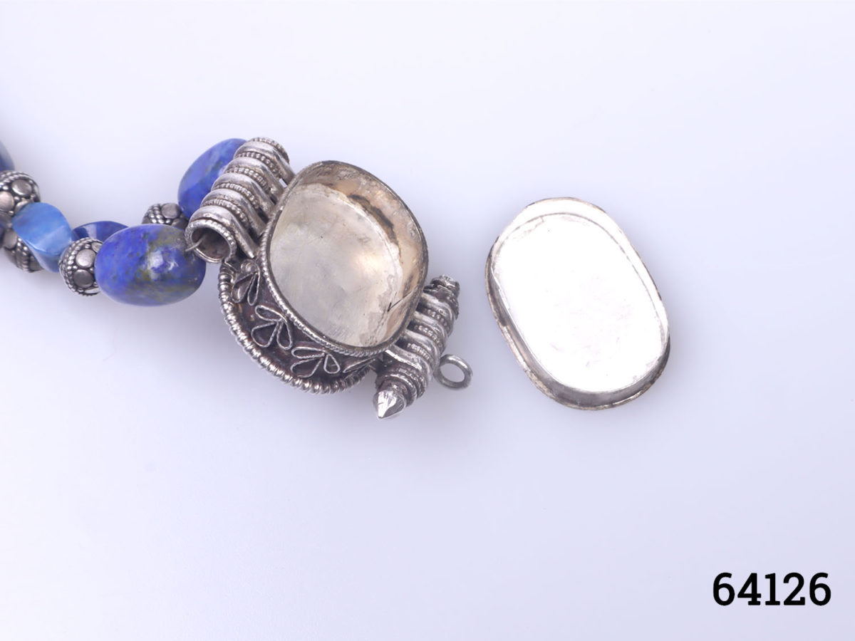 Vintage Tibetan silver necklace with turquoise and lapis lazuli beads and a lapis lazuli box pendant. Pendant has a secret compartment that opens at the back and measures 38mm long by 30mm wide Photo of pendant with back open showing hidden compartment