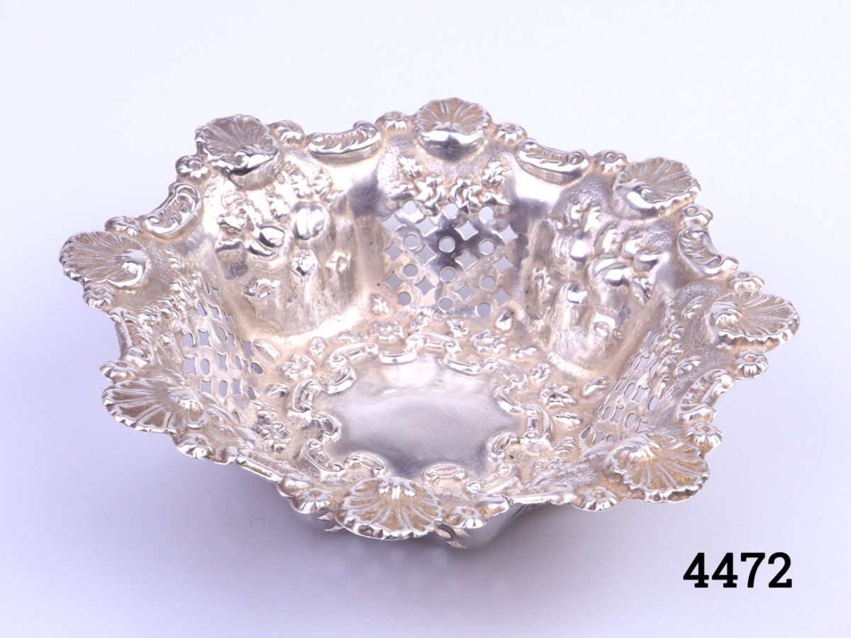 c1906 Birmingham assayed small sterling silver bonbon dish. Highly decorated with shells and pierced work. Measures 50mm in diameter at base and 90mm in diameter at top Photo of dish from a slight raised angle