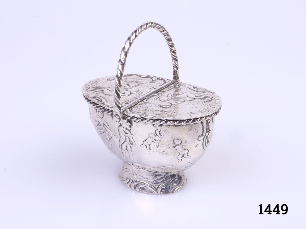 c1900 Dutch novelty silver snuff box in the form of a basket. Central hinged lid that opens both sides. Dutch hallmarks to the lid. Main photo of snuff box with handle upright and positioned in a diagonal angle