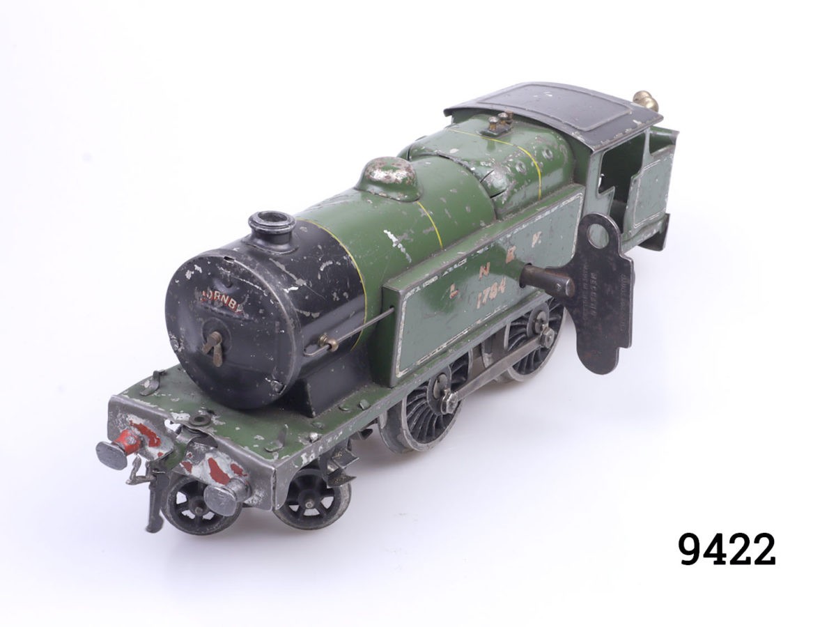 Vintage pre-war Hornby tank locomotive. In good working order. Key included. Main photo of locomotive seen from a diagonal angle with front end facing bottom left and key seen in position
