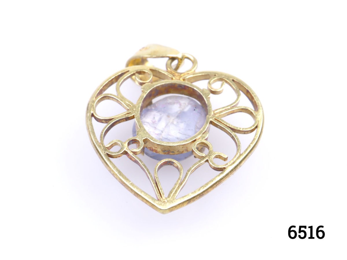 Vintage 18 karat gold heart pendant set with a star sapphire cabochon to the centre. Hallmarked GH18k on the pendant bail. Drop length 25mm Photo of back of pendant
