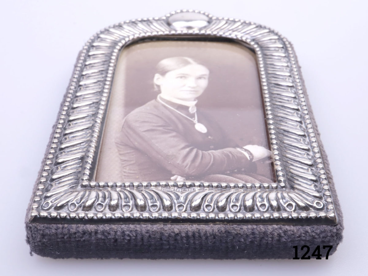 c1988 vintage Mappin & Webb sterling silver photo frame. Small arch shaped frame with blank cartouche at the top for personalising . Fully hallmarked to the bottom centre of the frame. Photo of frame laid on a flat surface