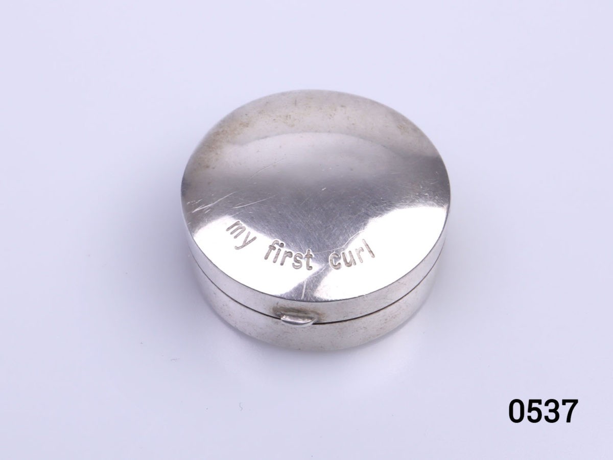 c1990s vintage small sterling silver circular box inscribed "My First Curl" Fully hallmarked to the base for London assay. Measures 30mm in diameter Photo of box seen looking from above