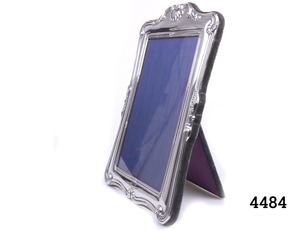 c1993 Sheffield assayed sterling silver photo frame. Made by Carr's of Sheffield Ltd. Fully hallmarked at the centre bottom of the frame. Photo of frame seen from an angled side view