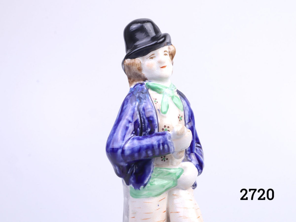 Vintage 2 sided Staffordshire Pottery figure. Water to one side, smartly dressed in bright colours with a happy smiling face and gin side looking dishevelled in grey and confused face. Close up photo of the healthy happy water drinker