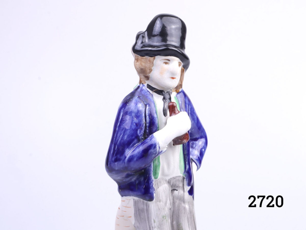 Vintage 2 sided Staffordshire Pottery figure. Water to one side, smartly dressed in bright colours with a happy smiling face and gin side looking dishevelled in grey and confused face. Close up photo of the top half of the gin drinker