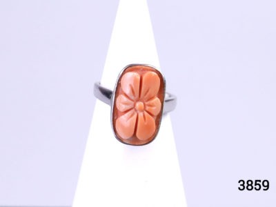 Modern 925 sterling silver ring with finely carved coral flower. Hallmarked 925. Ring size N / 6.5. Ring front measures 18mm by 10mm. Main photo of ring seen from the front and displayed on a stand
