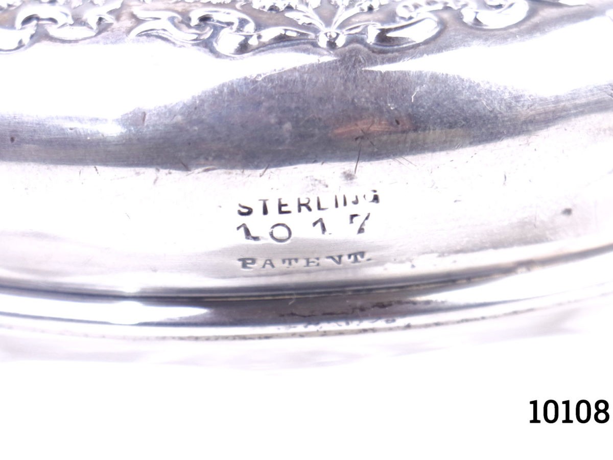 Sterling silver lidded glass pot. Vintage pot with heavily embossed silver lid Measures 85mm in diameter Close up photo of the silver hallmark