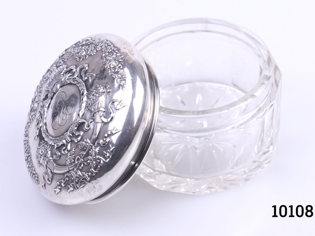 Sterling silver lidded glass pot. Vintage pot with heavily embossed silver lid Measures 85mm in diameter. Photo of the pot with lid removed and leaning up against the pot to the left
