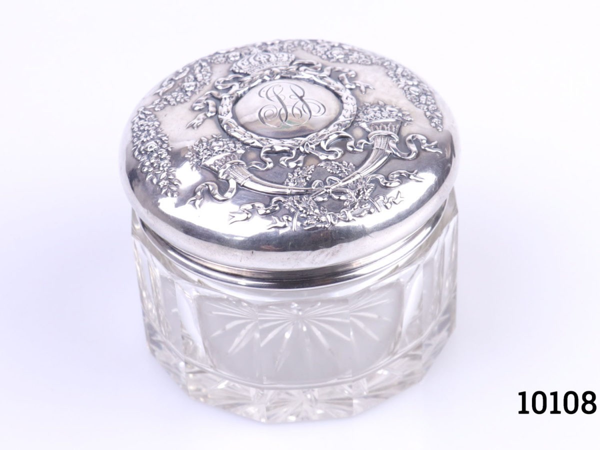 Sterling silver lidded glass pot. Vintage pot with heavily embossed silver lid Measures 85mm in diameter Photo of pot with lid in place and seen from a slight height