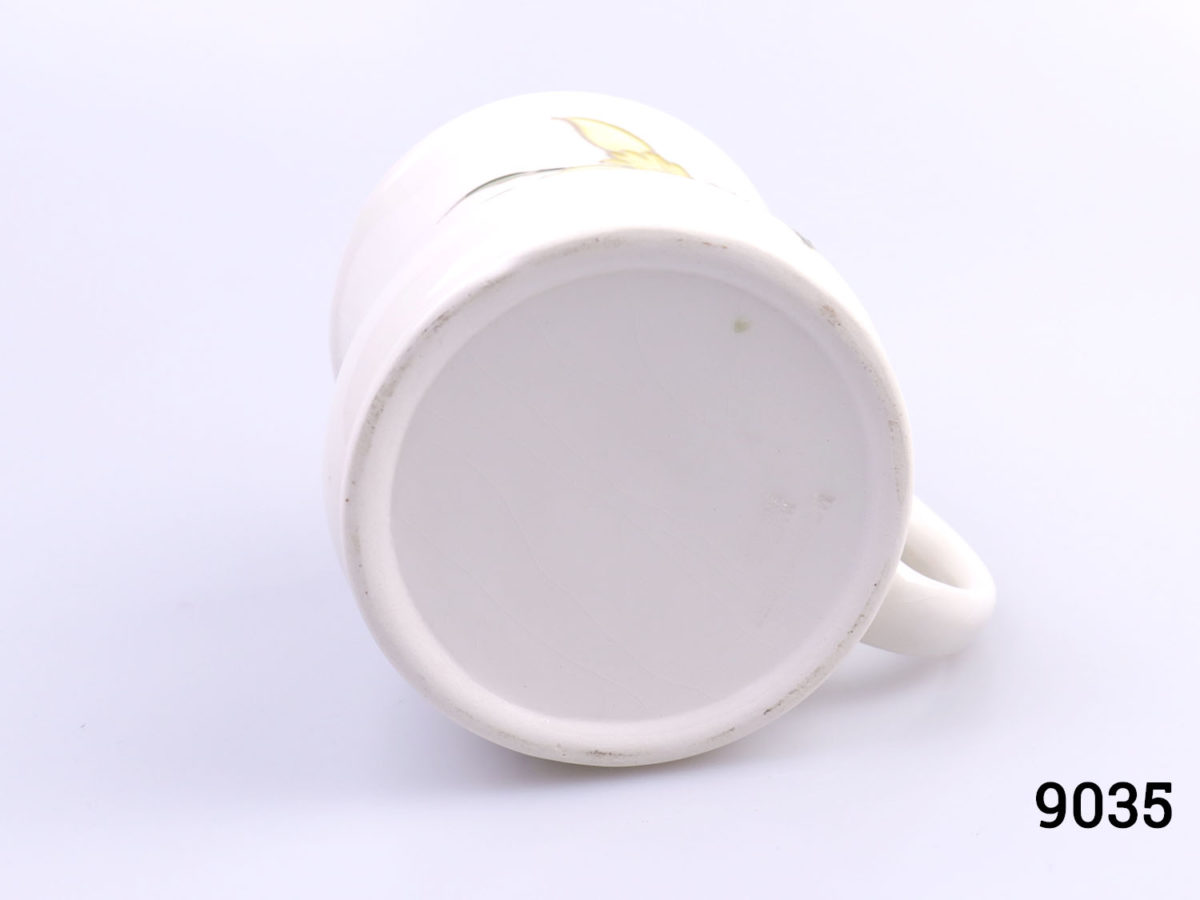 Vintage Moorcroft mug in daffodil pattern. Impressed Moorcroft mark to the base. c1980s. Measures 80mm in diameter at base Photo of base of mug just showing impressed Moorcroft stamp