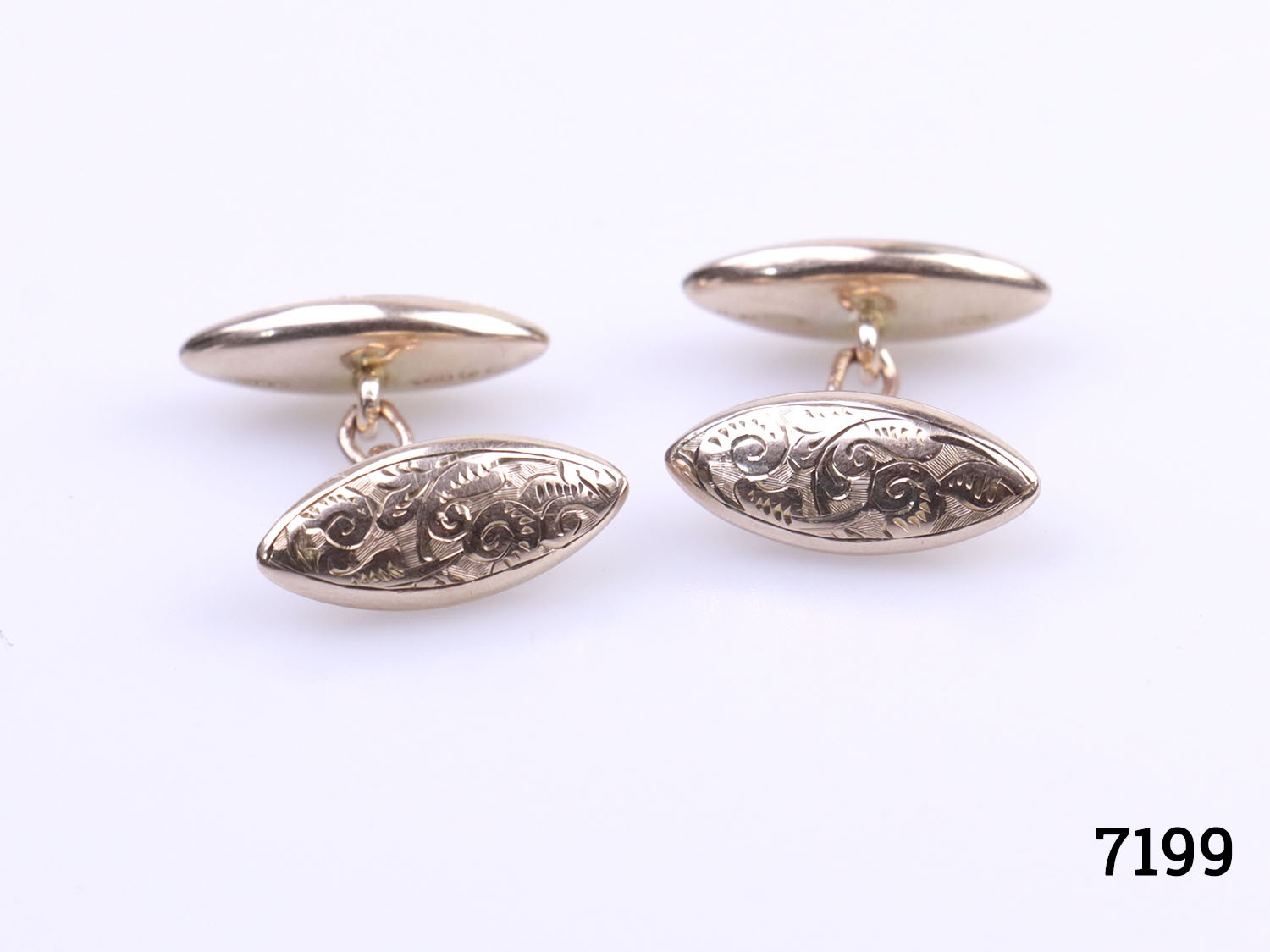 Vintage 9 karat gold oval cufflinks. Scrollwork design and hallmark on both ends and also hallmarked on each link of the chain. London assayed. Each end measures 20mm by 6mm with 24mm in length. Main photo showing one side of the scrollwork ends