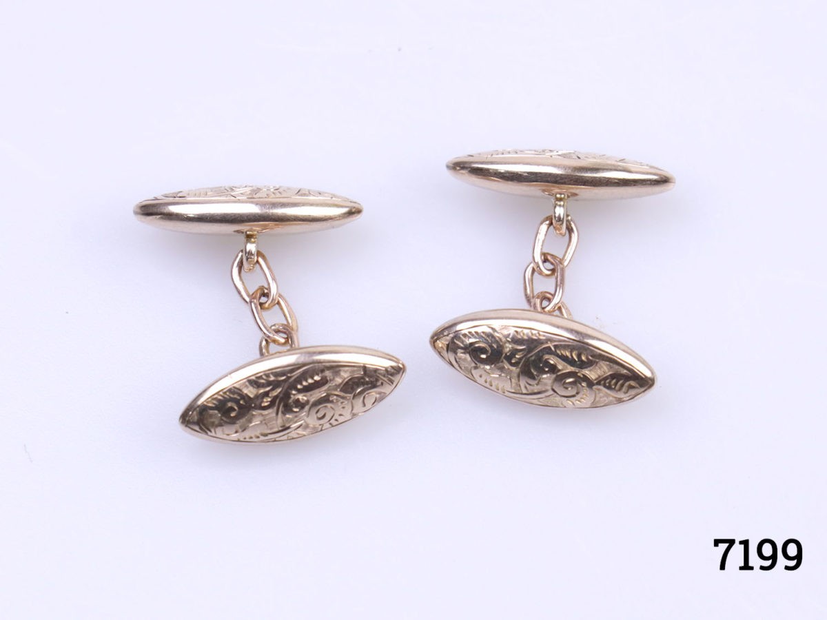 Vintage 9 karat gold oval cufflinks. Scrollwork design and hallmark on both ends and also hallmarked on each link of the chain. London assayed. Each end measures 20mm by 6mm with 24mm in length. Photo of cufflinks laid out showing the full length