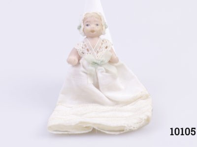 Vintage miniature bisque doll in Victorian hat and dress. Moving arms and legs. Main photo of doll sitting up and looking straight at camera