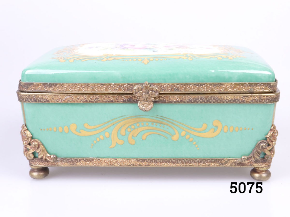 19th Century Paris porcelain box. Hand-painted box in sea green with floral design to centre of the lid with ormolou gilt metal edging and brass feet. Hand-painted picture signed by Renan Photo of front of box with lid closed