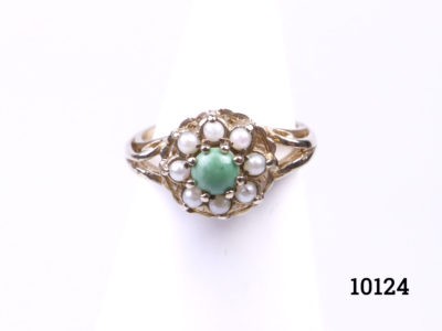 Vintage 9 karat gold ring set with a pale green turquoise to the centre surrounded by 8 tiny seed pearls. Ring size K / 5.25 and weight 2.9grams Main photo showing ring on a display stand and seen from the front