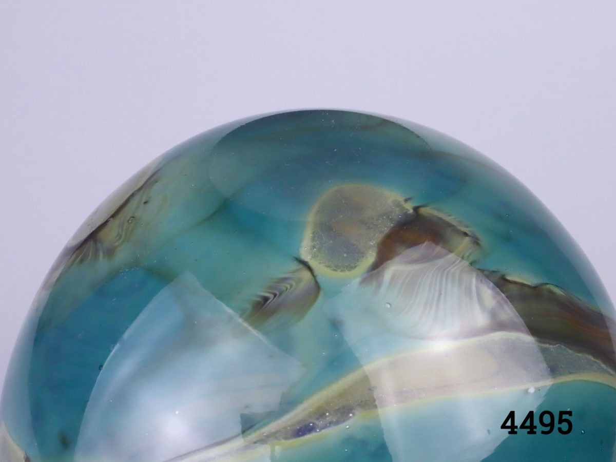 Vintage Mdina glass vase . 'Sea Swirl' pattern in turquoise blue with amber coloured swirls. Bulbous shape with turned lip. Signed Mdina to the base. Measures 40mm in diameter at base, 130mm in diameter at widest point, 82mm diameter across the top and 22mm diameter opening. Photo of base of vase