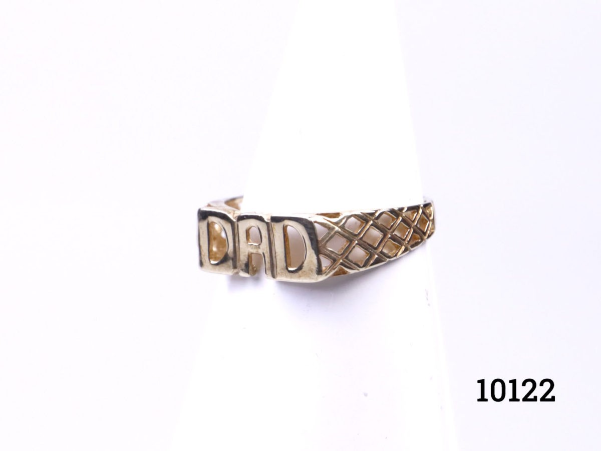 Vintage 9 karat gold "DAD" ring. Ring with Dad spelt out at front with nice lattice work to the shoulders. Hallmarked 375 for 9 karat gold. Ring size R / 8.5 and weight 1.7grams (Band is very fine at the back) Main photo of ring on a display stand and seen from a side angle showing the lattice work on the shoulder