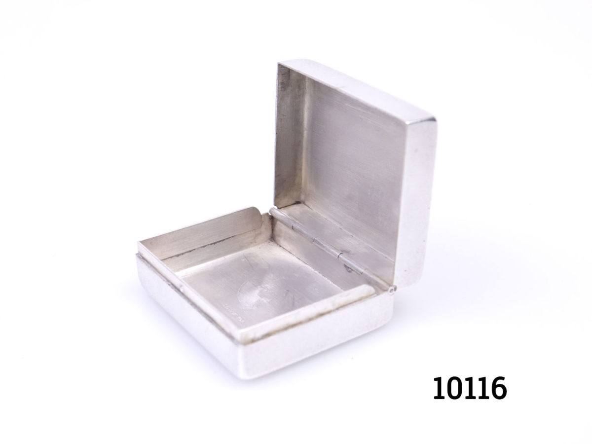 Vintage 950 grade silver pill/ snuff box. Hallmarked sterling 950 inside. Scrollwork to the lid with a vacant cartouche for personalisation. Photo of box from a diagonal side angle shown with lid open