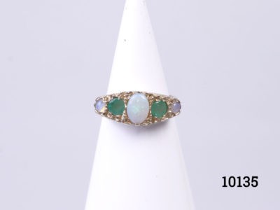 Vintage 9 Karat yellow gold ring set with oval opal to the centre with round cut emerald and blue smaller opals to either side. Box included (May not be box shown) Ring size M / 6. Ring weight 3.8grams. mAIN PHOTO OF RING ON A CONE DISPLAY STAND LOOKING STRAIGHT ON AT RING FRONT