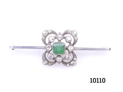 Vintage sterling silver bar brooch decorated with an industrial emerald to the centre surrounded by cubic zirconia Main photo showing the brooch from front
