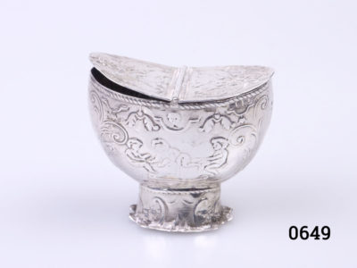 c1892 London import sterling silver basket shaped box. Ornately embossed decoration which is worn in places. Centrally hinged double sided opening. Fully hallmarked on the outer rim at the top of the basket and on the lid. Main photo of side view abglew of basket showing the full hallmark at top of rim and cherub decoration to the main body