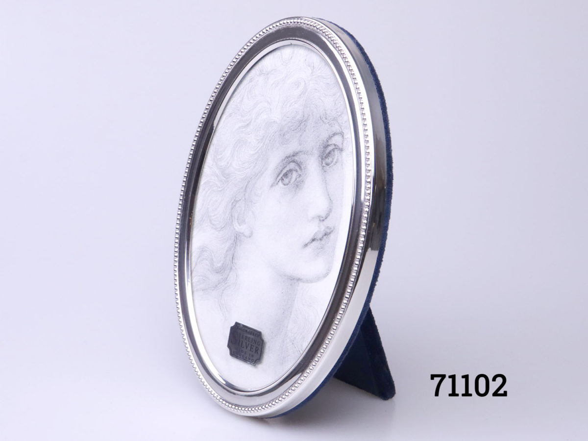 c1994 925 Sterling silver oval photo frame. Fully hallmarked to the side for Sheffield assay by Carr's. Photo of frame from a slight diagonal angle