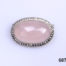 Sterling silver oval brooch set with rose quartz cabochon to the centre in a marcasite frame. Trombone clasp for added security. Main photo of brooch front