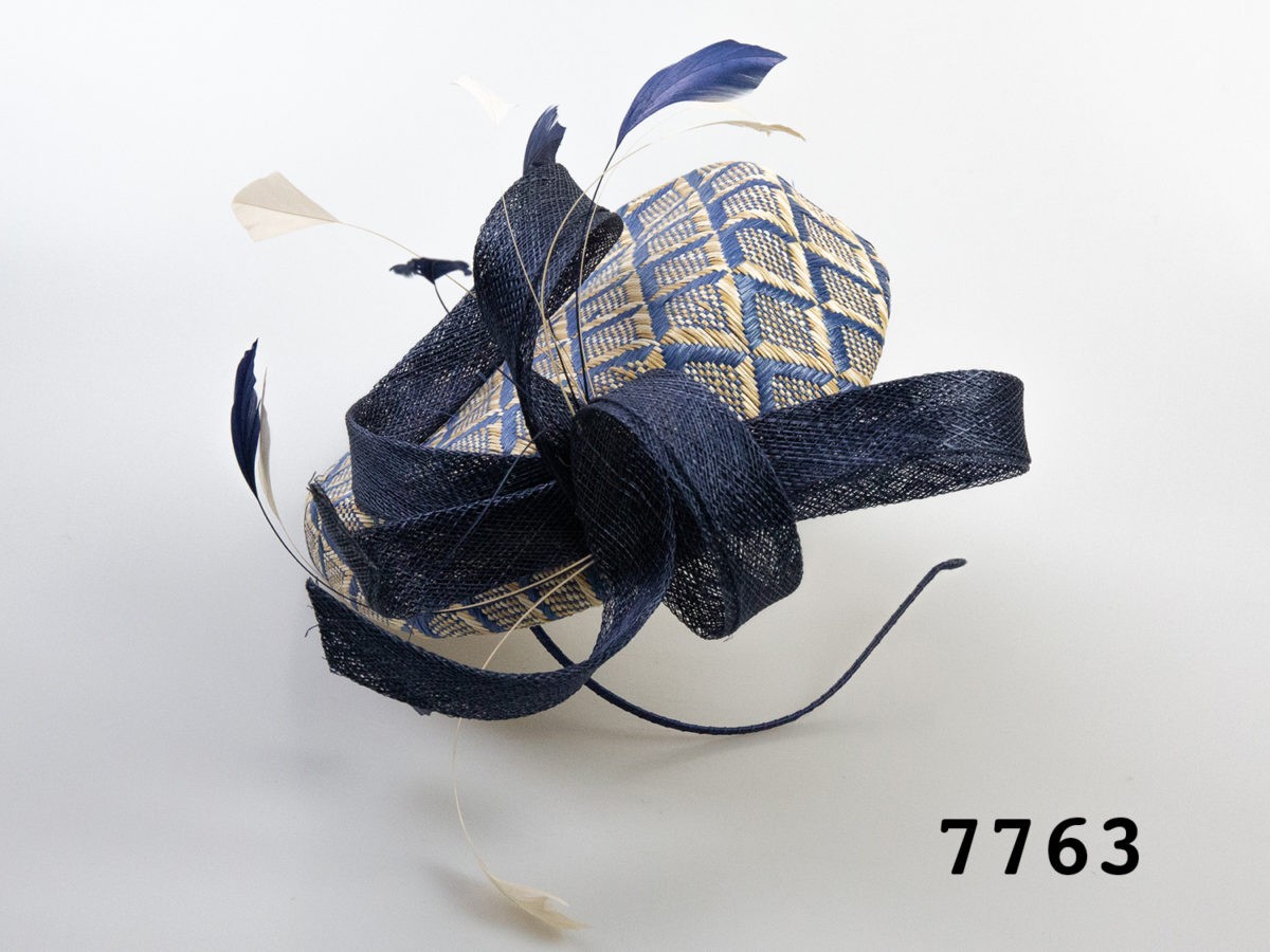 Vintage Jasper Conran fascinator hat. Blue and cream straw hat with a hessian lining and accentuated with blue and cream feathers and blue hessian ribbon.  Attach with thin blue alice band. Photo of side of hat showing feathers and ribbon area