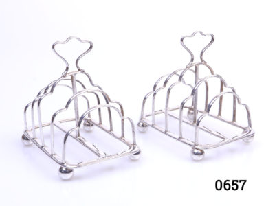 c1897 Victorian toast racks. Pair of fully hallmarked sterling silver toast racks by Atkin Brothers. Sheffield assayed. Each toast rack measures approximately 80mm long by 60mm wide and 80mm tall at highest point in the centre and weighs 55.4 grams. Main photo of both toast racks lined side by side and at a slight angle