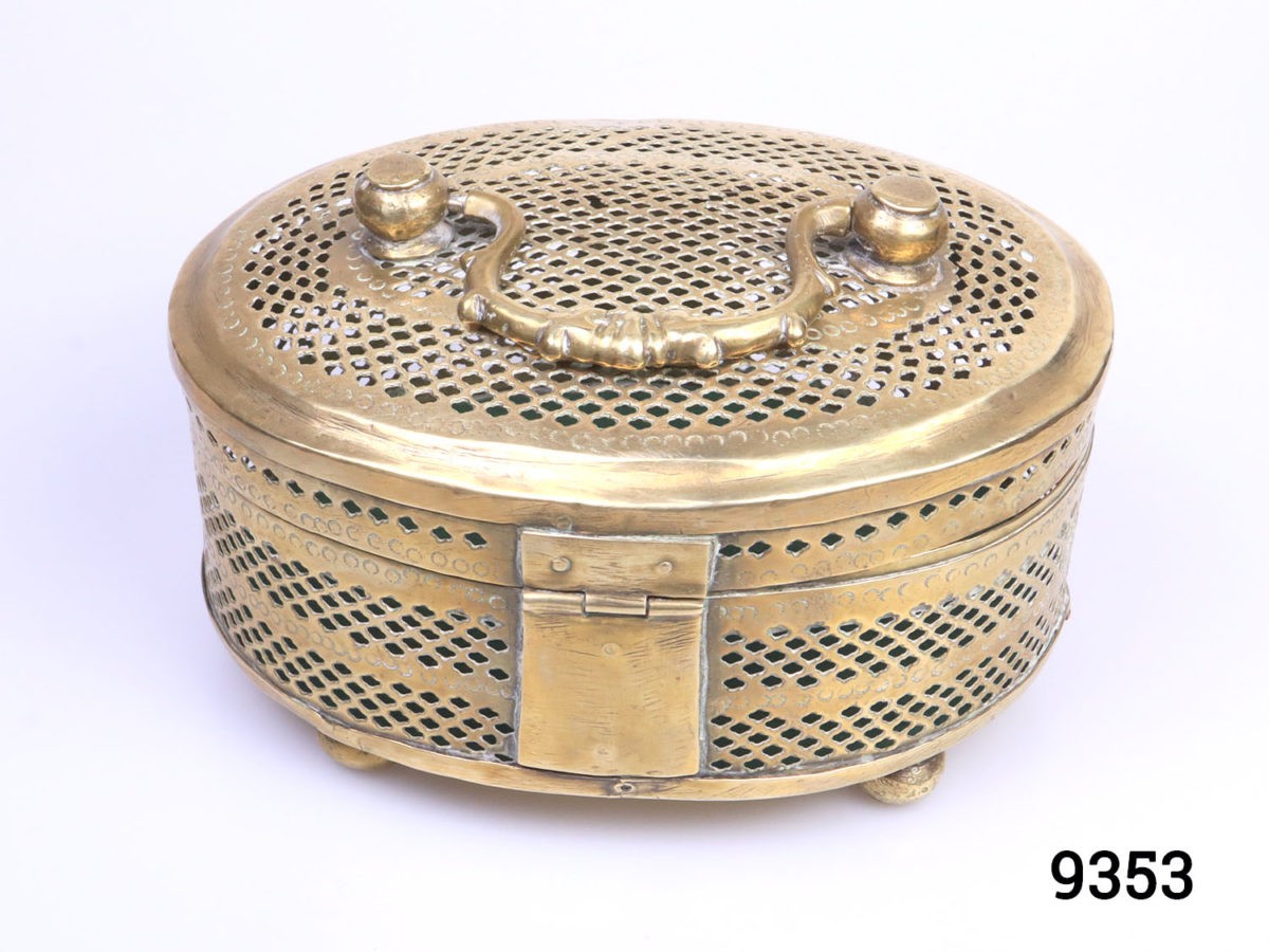 Vintage solid brass casket. Perforated solid brass casket on four round brass legs possibly used as a cricket cage or betel leaf storage case. Photo of the back of casket showing the solid hinge