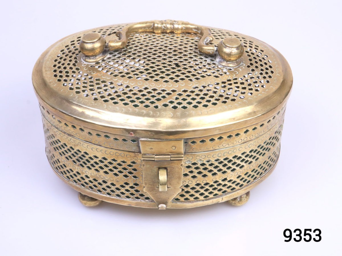 Vintage solid brass casket. Perforated solid brass casket on four round brass legs possibly used as a cricket cage or betel leaf storage case. Photo of casket from a slightly raised angle